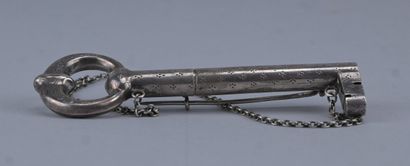Silver needle case in the shape of a key...