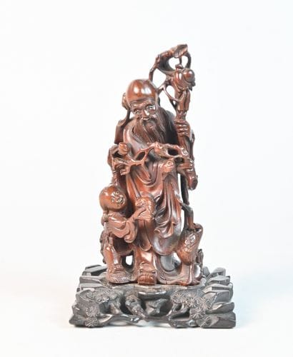 Chinese carved wooden figurine depicting...
