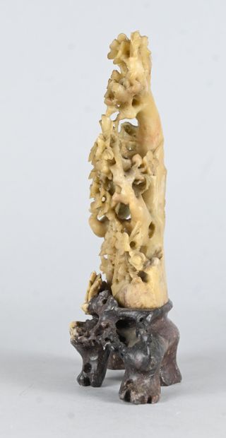 Openwork soapstone floral sculpture on base...