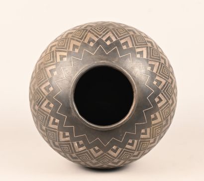 Spherical metal vase with geometric and foliate...