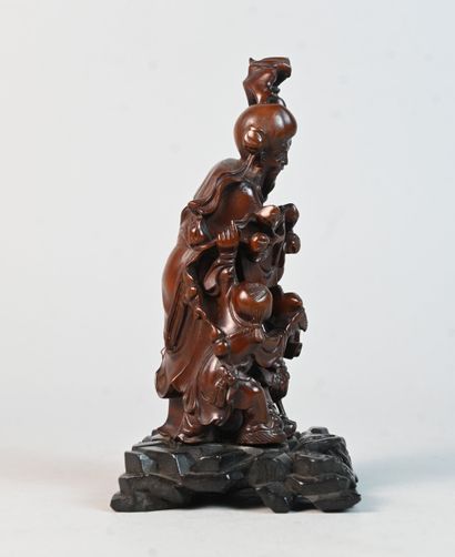 Chinese carved wooden figurine depicting...