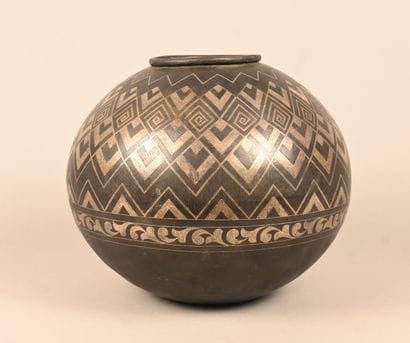 Spherical metal vase with geometric and foliate...