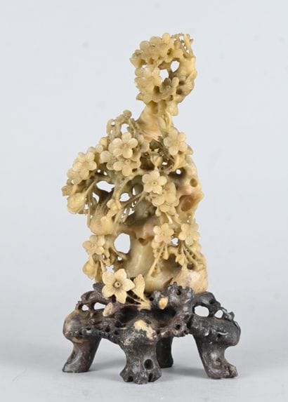 Openwork soapstone floral sculpture on base...