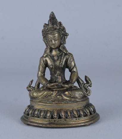 Bouddha tibétain en bronze sur base lotiforme...