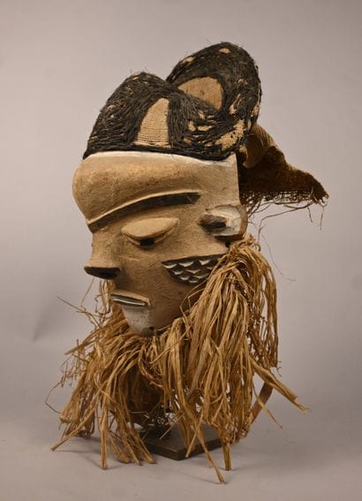 Pende mask with textile headdress and plant...
