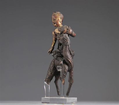 Chinese Sculpture of a Figure Riding a Dragon

A...