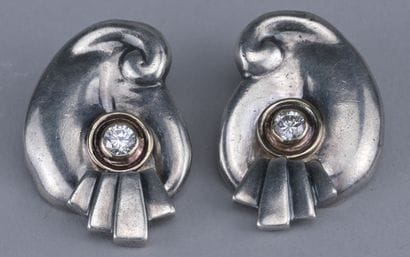 Pair of silver and gold earrings

Pair of...