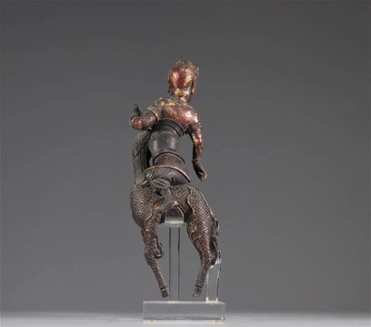 Chinese Sculpture of a Figure Riding a Dragon

A...
