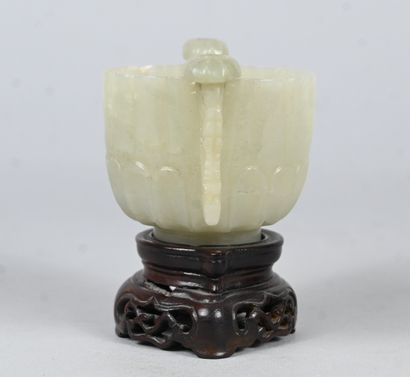 White jade bowl with carved handles on wooden...