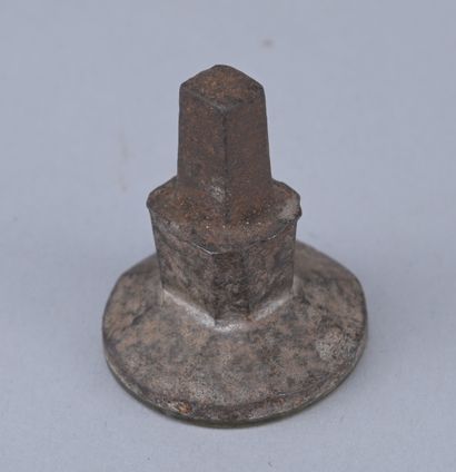 18th-century metal seal with a coat of arms

An...