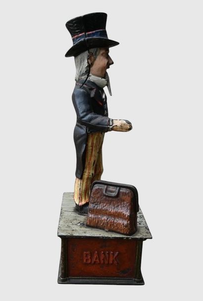 Mechanical “Uncle Sam” piggy bank made of...