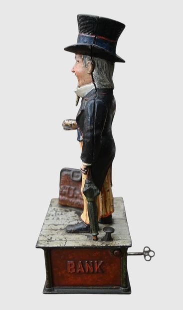 Mechanical “Uncle Sam” piggy bank made of...