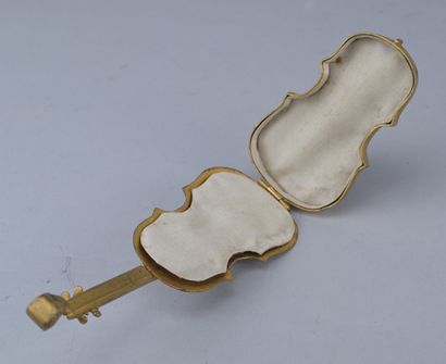 Brass box shaped like a cello, circa 1900

A...