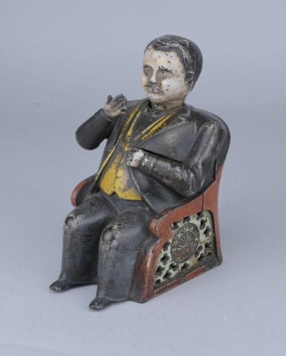 Mechanical piggy bank made of painted cast...