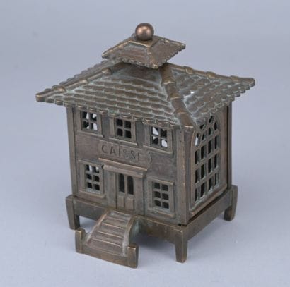Brass piggy bank in the shape of a cash register,...