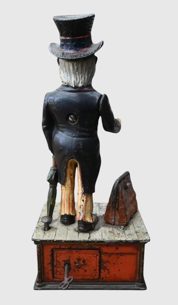 Mechanical “Uncle Sam” piggy bank made of...