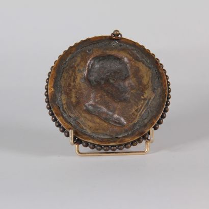 Bronze medallion with a brown patina depicting...