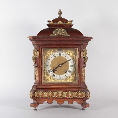 Wooden table clock with gilded bronze trim...