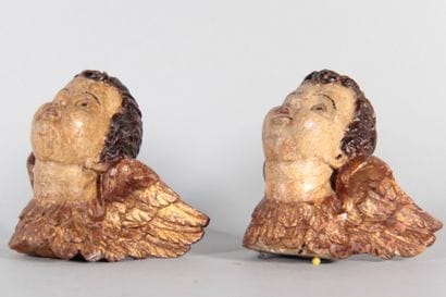 Pair of winged cherub heads carved from wood,...