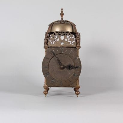 Brass lantern clock with striking mechanism...