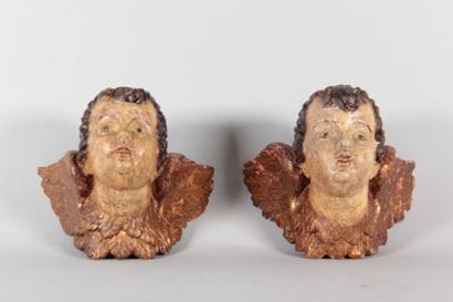 Pair of winged cherub heads carved from wood,...