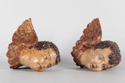 Pair of winged cherub heads carved from wood,...