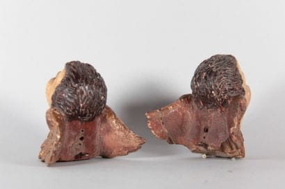 Pair of winged cherub heads carved from wood,...