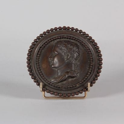 Bronze medallion with a brown patina depicting...