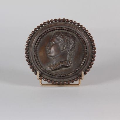 Bronze medallion with a brown patina depicting...