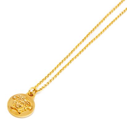 VERSACE
Gilded metal necklace holding a circular...