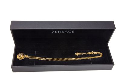 VERSACE
Gilded metal necklace holding a circular...