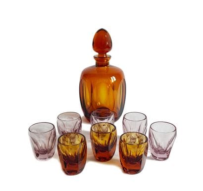 A port or liqueur set in faceted tinted glass,...