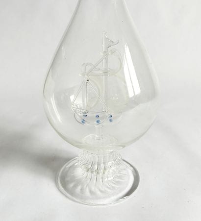 Clear glass single-flower vase with an interior...