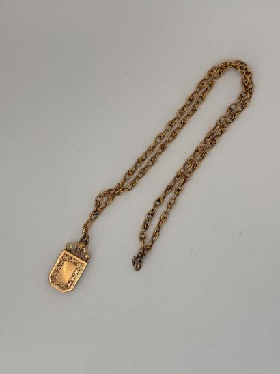 Gold chain holding a reliquary locket or...