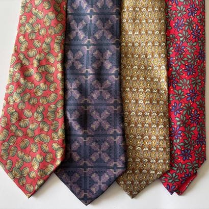 HERMES 
Set of four ties with printed geometric...