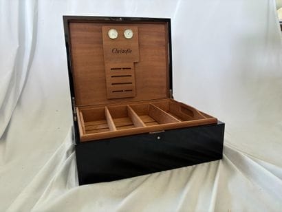 CHRISTOFLE. 
Black lacquered teak cigar box,...