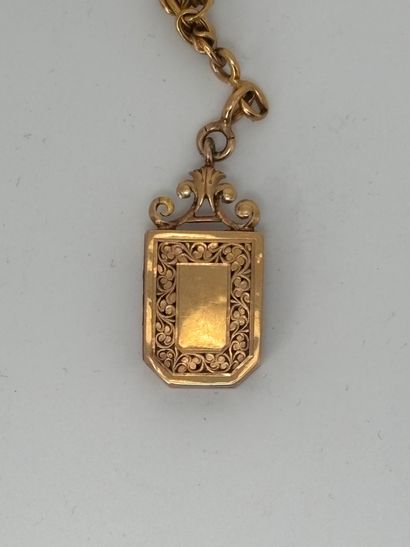 Gold chain holding a reliquary locket or...