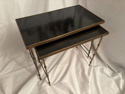 Maison Jansen. 
Two nesting tables in gilt...