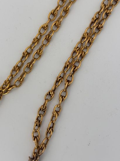 Gold chain holding a reliquary locket or...