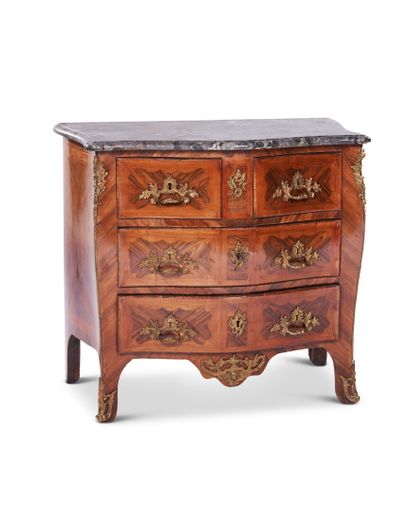 A curved chest of drawers in violet and rosewood...