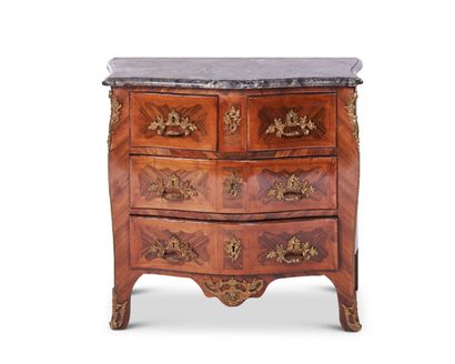 A curved chest of drawers in violet and rosewood...