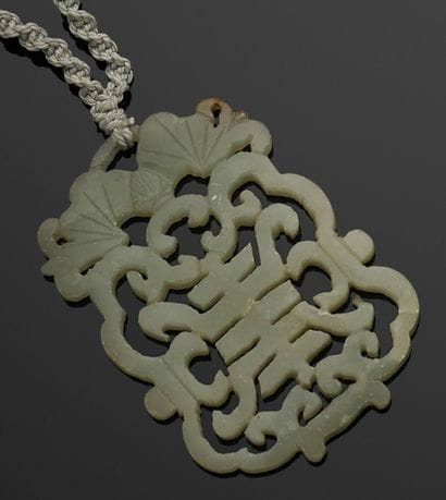 Twisted cord necklace holding an openwork...