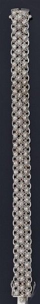 BRACELET articulé en or gris 18 k 750°/oo...