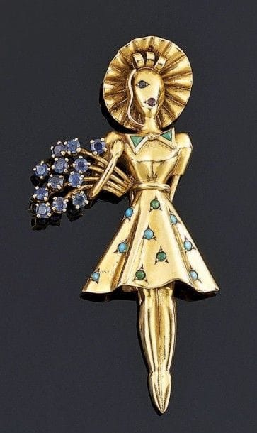 BROCHE figurant une jeune fille tenant un...
