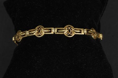 BRACELET articulé en or jaune 750°/oo, les...
