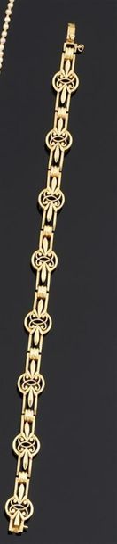BRACELET articulé en or jaune 750°/oo, les...