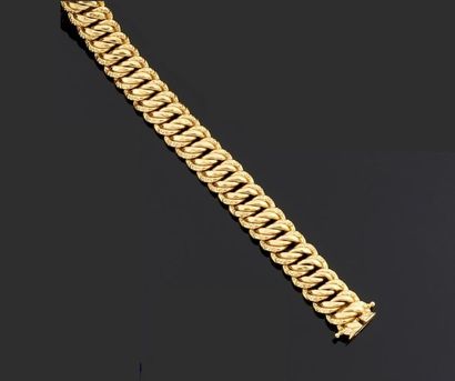 BRACELET articulé en or jaune 750°/oo, les...