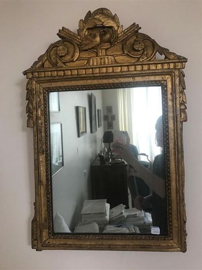 MIROIR en bois et stuc dorés, orné d'un fronton...