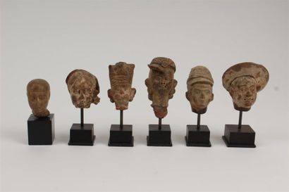 SIX TETES en pierre sculptée et terre cuite...