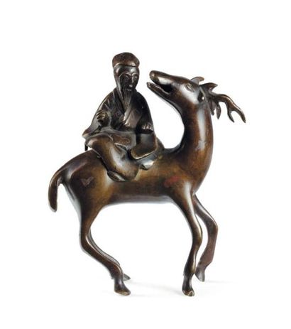 Personnage sur un cerf en bronze. Chine XIXe...